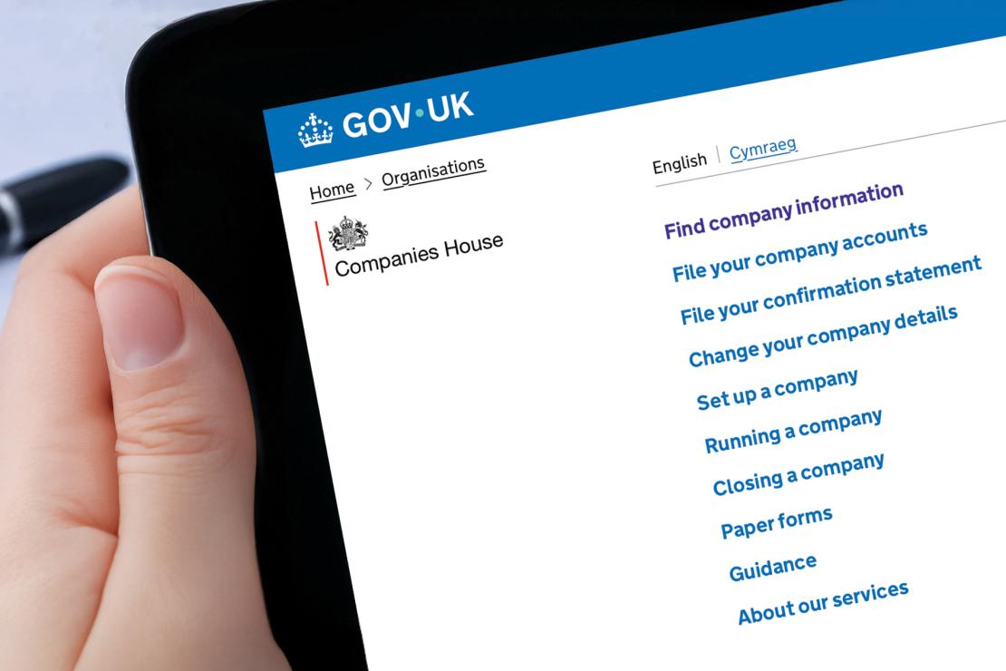 Person reading a Companies House webpage on a screen, researching new director identity verification requirements