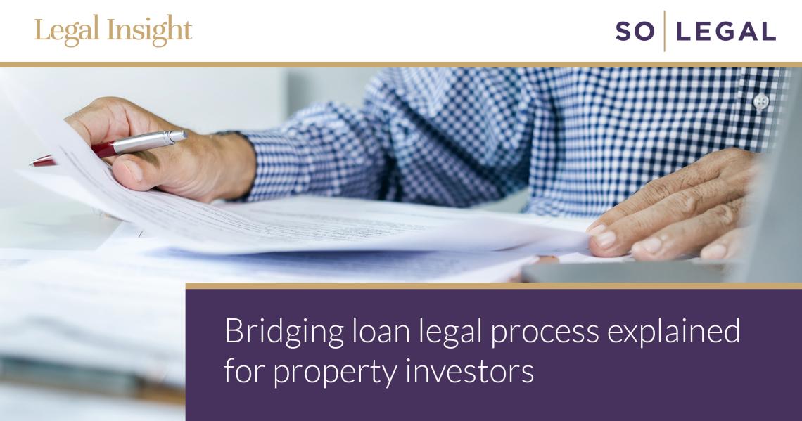Property investor reviewing documents on a laptop during a bridging loan transaction.