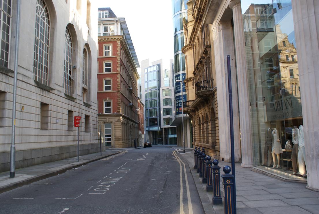 Commercial street with shops and business premises in an urban setting