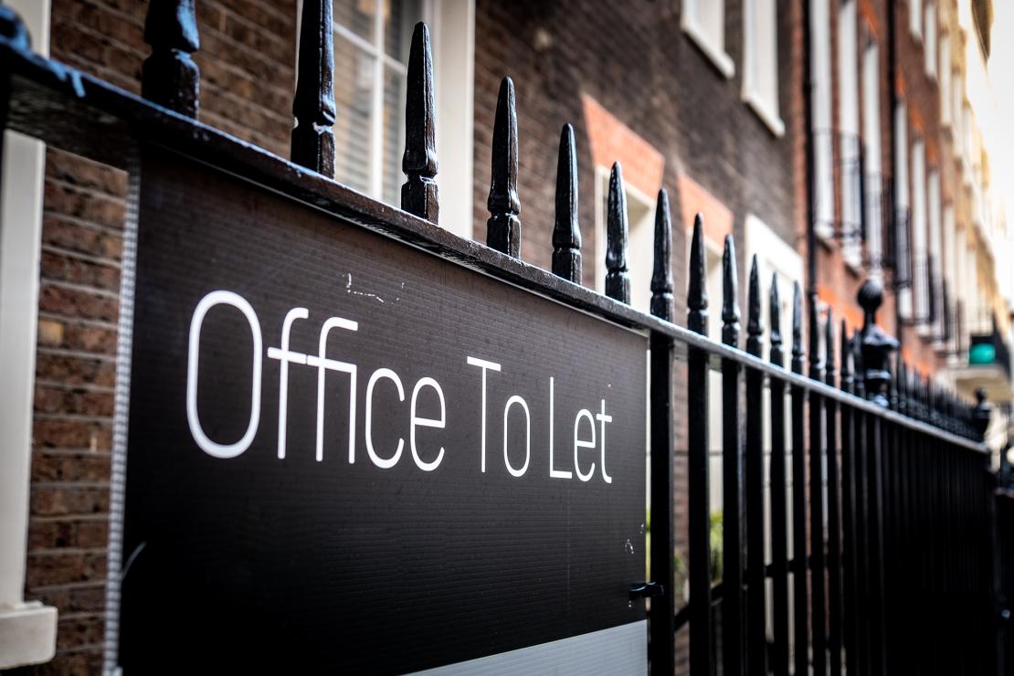 Office to let sign outside commercial property building in an urban setting