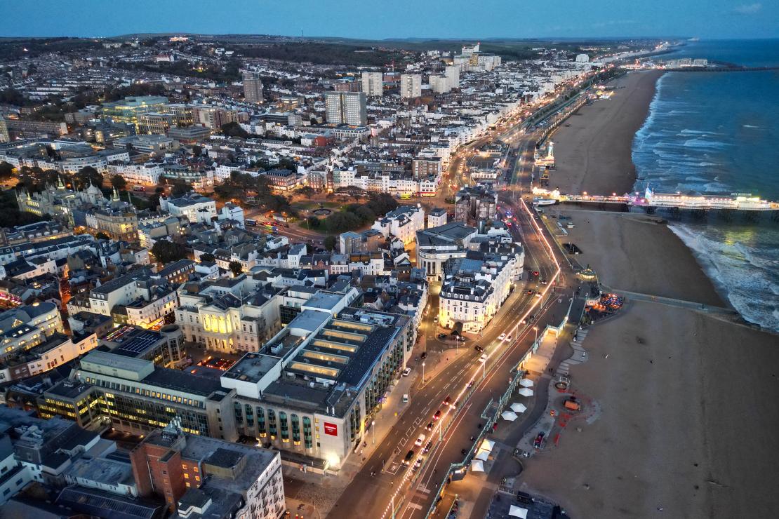 Aerial view of a coastal city with commercial and mixed-use buildings, representing commercial property investment and portfolios