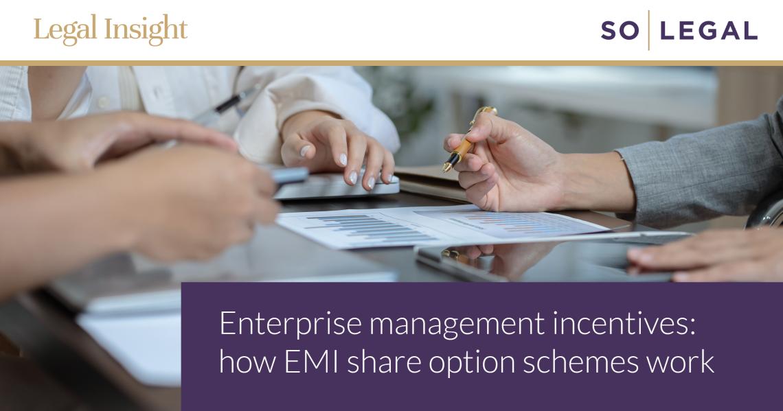 Business professionals discussing financial documents during a meeting about EMI share option schemes and employee incentives