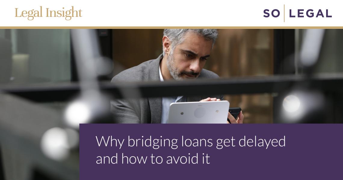 Investor checking a tablet and phone while arranging a bridging loan.