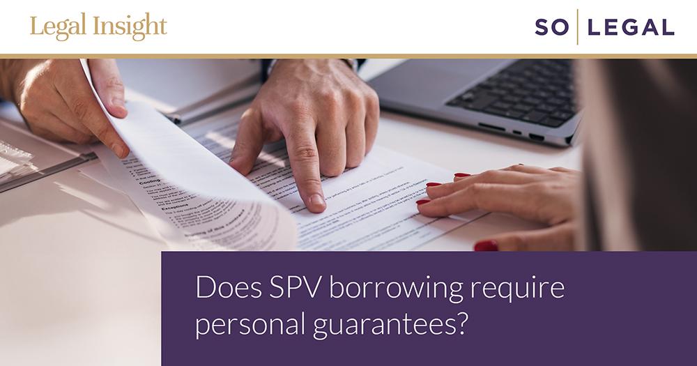 Person reviewing terms and personal guarantees as part of an SPV property borrowing transaction.