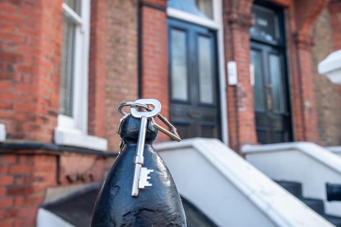 House keys outside a residential property for transfer of equity services.